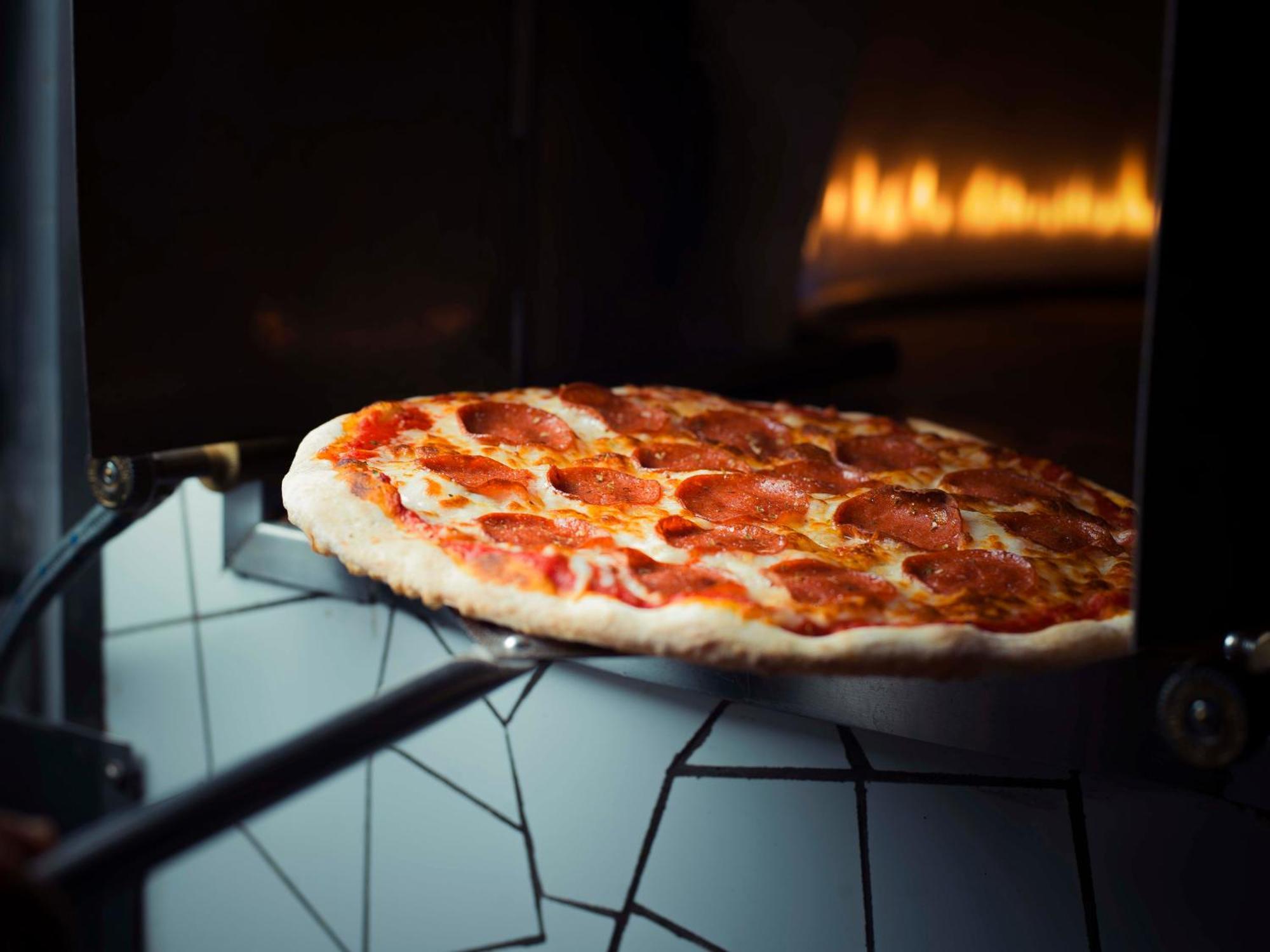 Sheraton Dammam Hotel & Convention Centre Exterior foto Pizza being removed from a wood-fired oven